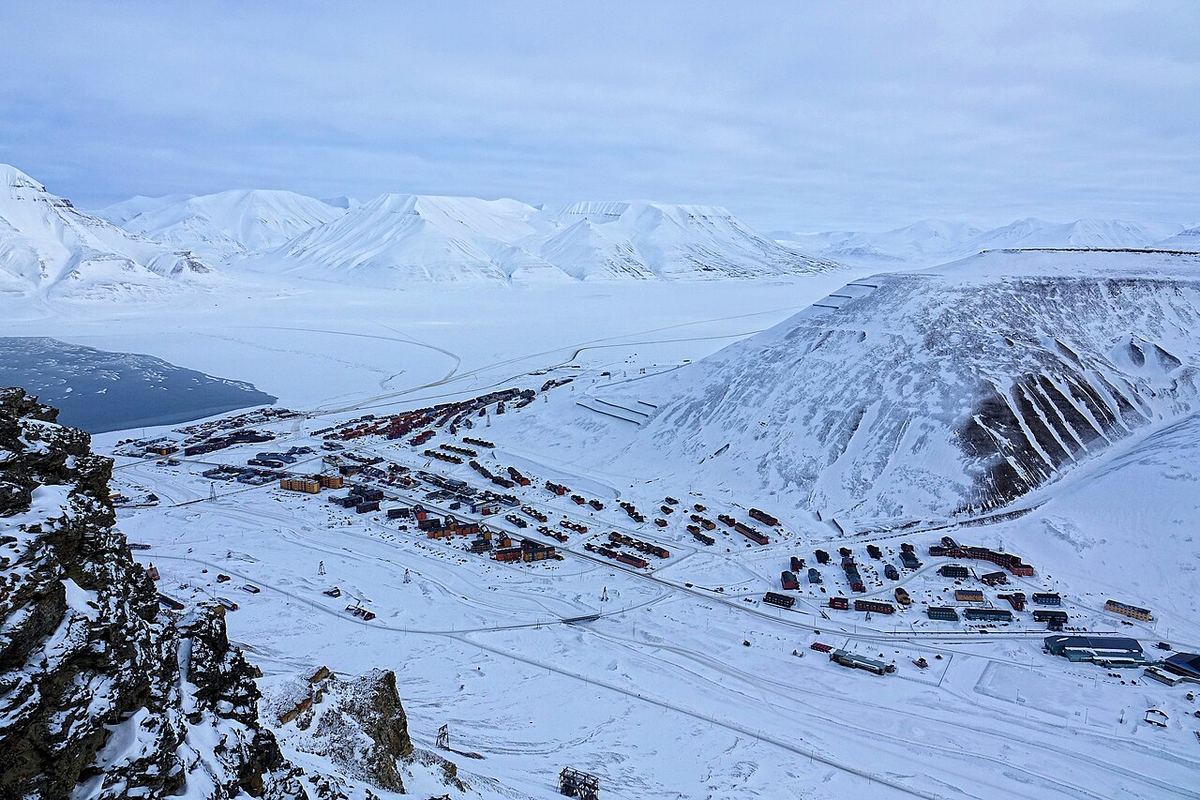 Vedere a părților mai noi ale orașului Longyearbyen, pe malul estic al râului, cu valea Adventdalen în fundal, sub Operafjellet.