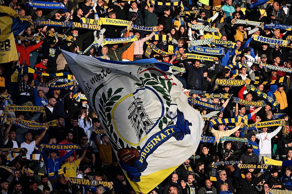 Suporteri ai echipei Frosinone Calcio cu steaguri și tifo în tribună, la un meci de fotbal.